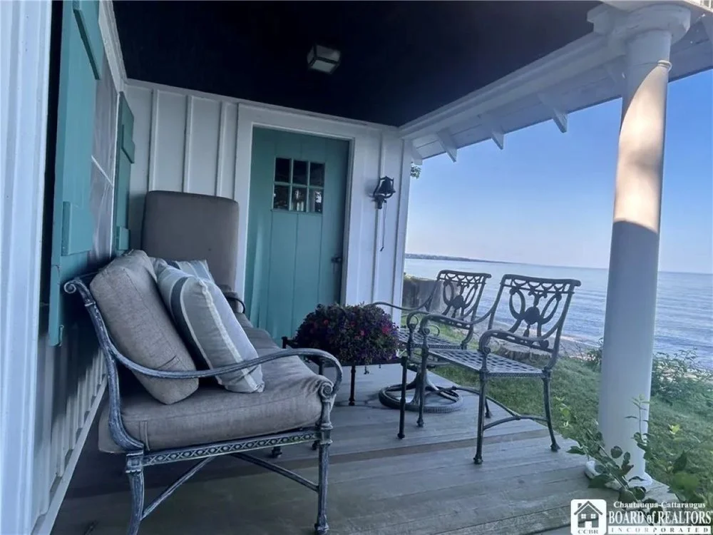 Covered deck at Fisher Price Toy co-creator's original cottage in Fredonia, NY, on sale for $399,000