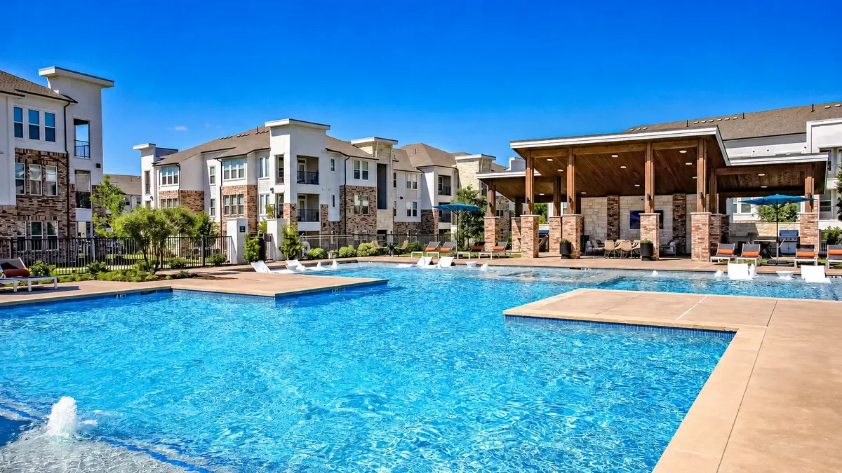 Pool surrounded by an apartment community